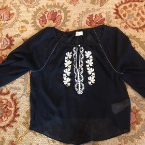 Navy blue Hollister sheer top with white flowers.